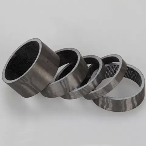 Carbon stem spacer set showing multiple spacer heights for stack adjustment and riding position tuning